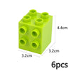 A lime green set of six chunky building blocks with circular holes for construction.