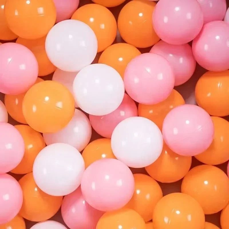 A close-up of a large pack of colorful plastic balls in shades of orange, pink, and white.