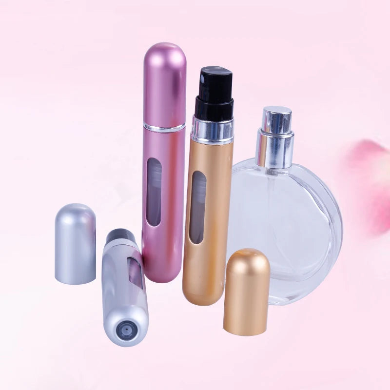 A set of five travel-friendly refillable perfume spray bottles in various metallic colors including pink, gold, and silver.