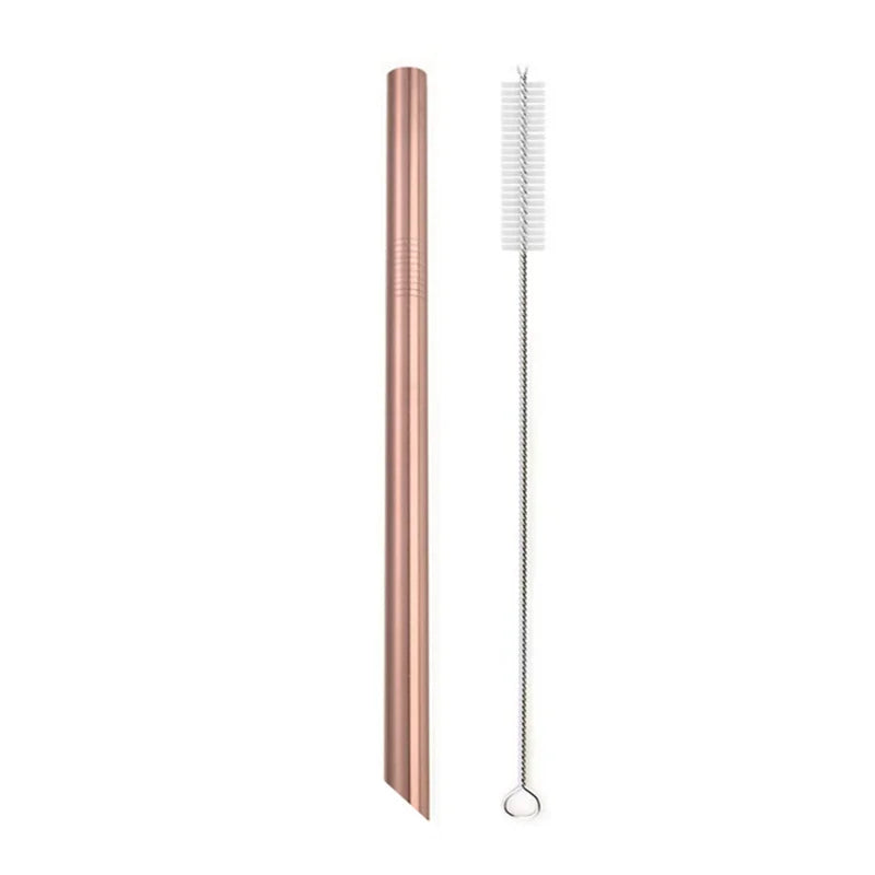A tall, rose gold reusable stainless steel drinking straw with an attached cleaning brush.