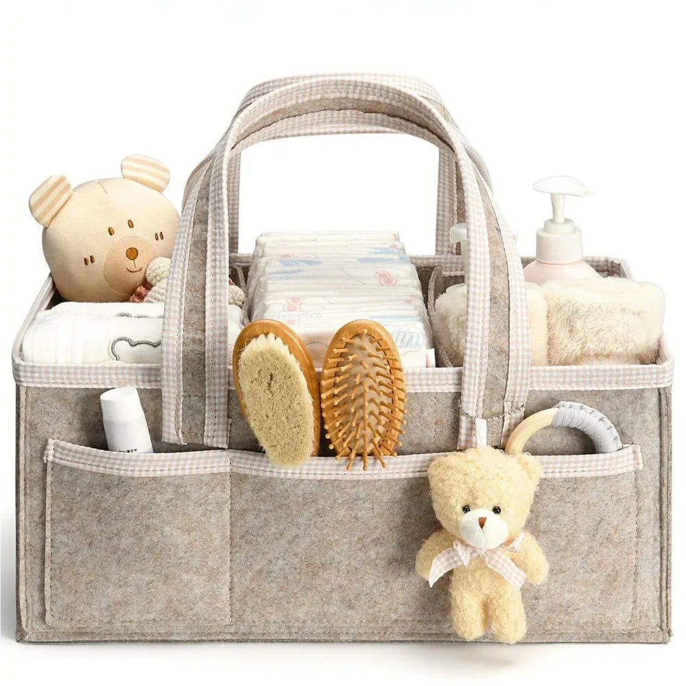 A beige floral diaper organizer bag filled with baby grooming items like brushes and teddy bears.