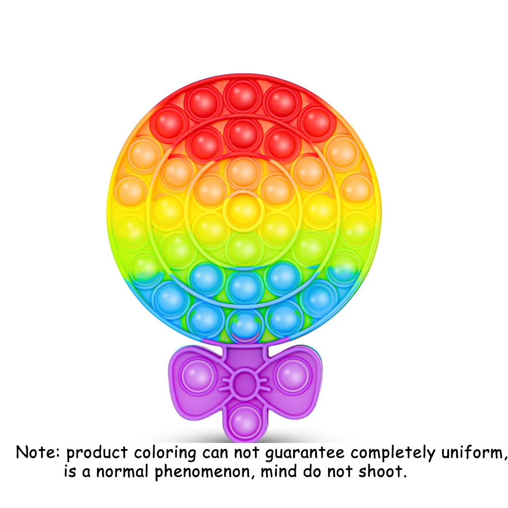 A colorful rainbow pop-it fidget board with multiple colored bubbles and a purple stopper.