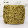 A ball of metallic gold silk crochet yarn used for knitting and macrame.