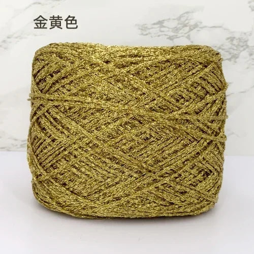 A ball of metallic gold silk crochet yarn used for knitting and macrame.
