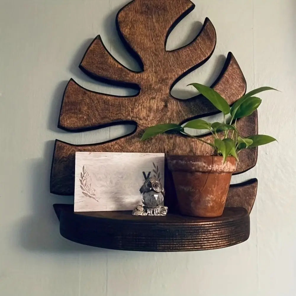 A rustic wooden wall-mounted storage rack featuring a plant and decorative mossy stone.
