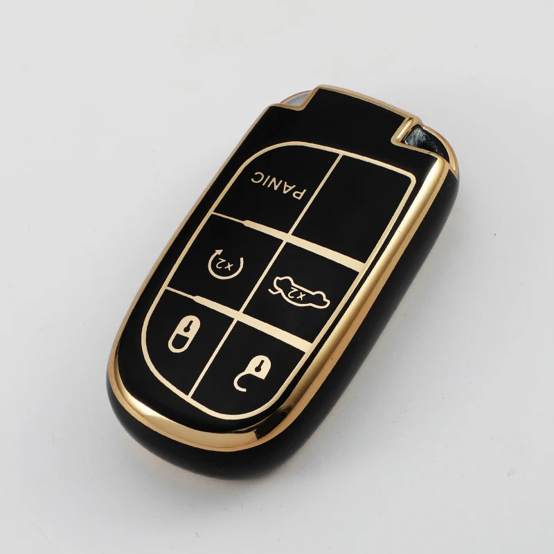 A black and gold durable TPU car key case cover with panic and lock buttons.