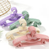 A set of ten adjustable baby clothes hangers in various pastel colors including purple, mint green, cream, and pink.