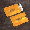 Two orange RFID protection cards are shown against a dark background with a payment card nearby.