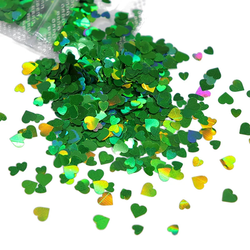 A pile of shiny holographic green heart-shaped sequins for resin crafts.
