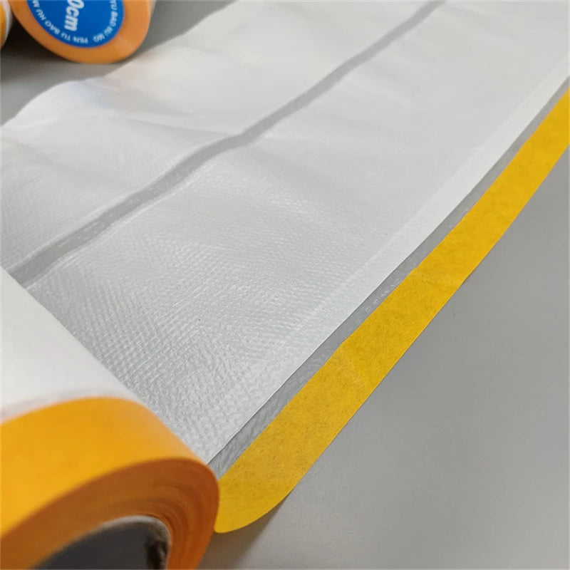 Roll of clear masking film with yellow edge used for painting protection.