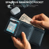 A hand holds a black slim pop-up wallet displaying US banknotes and various global currencies.