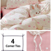 A pink and white comforter with bunny embroidery and four corner ties for easy fixing.