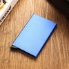A blue slim metal RFID blocking card holder with a pop-up design resting on a wooden surface.