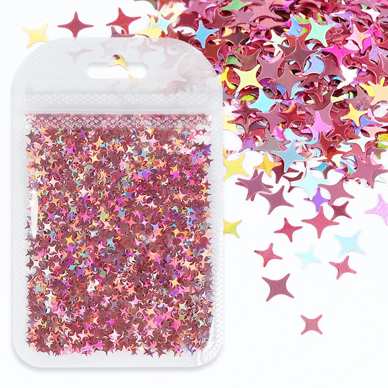 A clear plastic pouch filled with shiny holographic pink and purple star sequins for resin crafts.