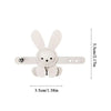 A white bunny-shaped bag charm keychain with small ears and a round body.