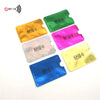A collection of colorful RFID blocking aluminum card holders in green, yellow, pink, and blue.