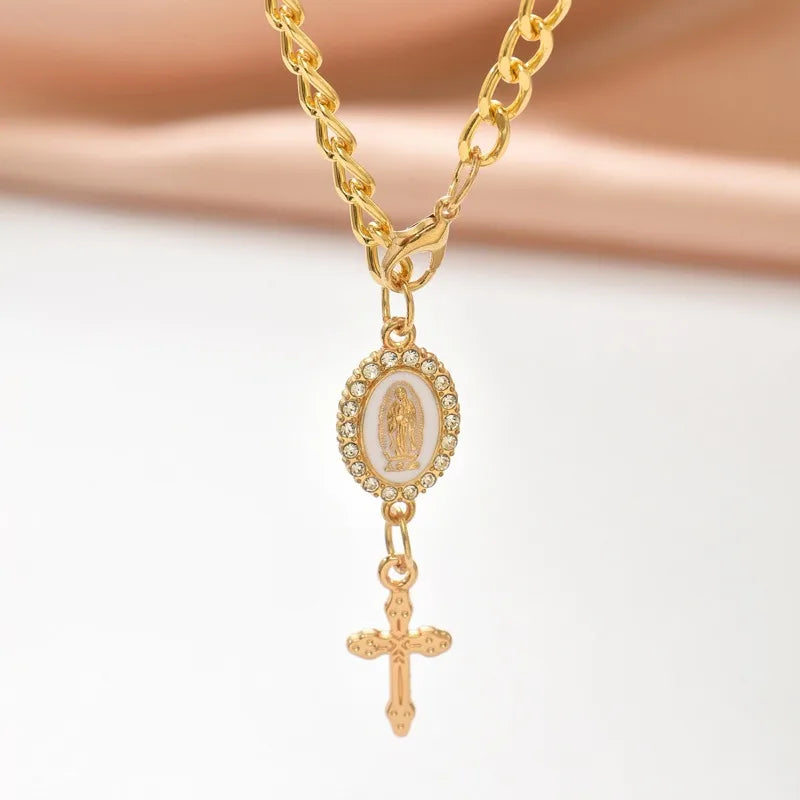 Gold chain rosary necklace featuring a medallion and cross pendant
