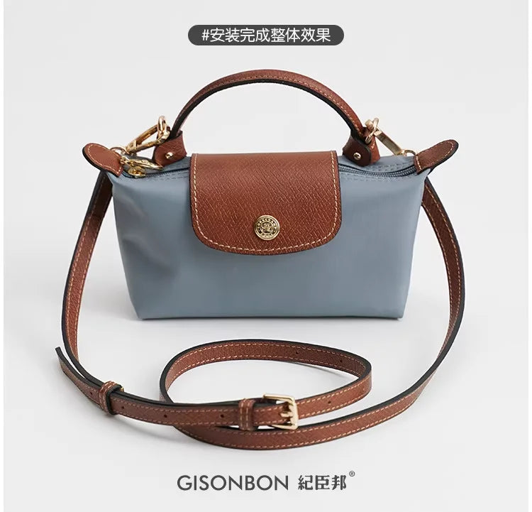 A light blue leather mini bag with brown stitching and a matching leather strap set.