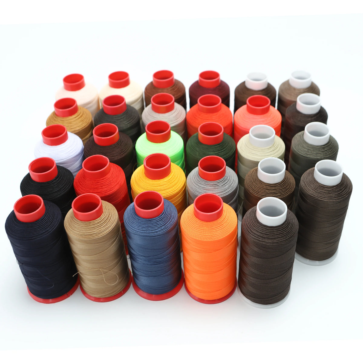 A collection of various colored heavy-duty nylon bonded thread spools arranged in a row.