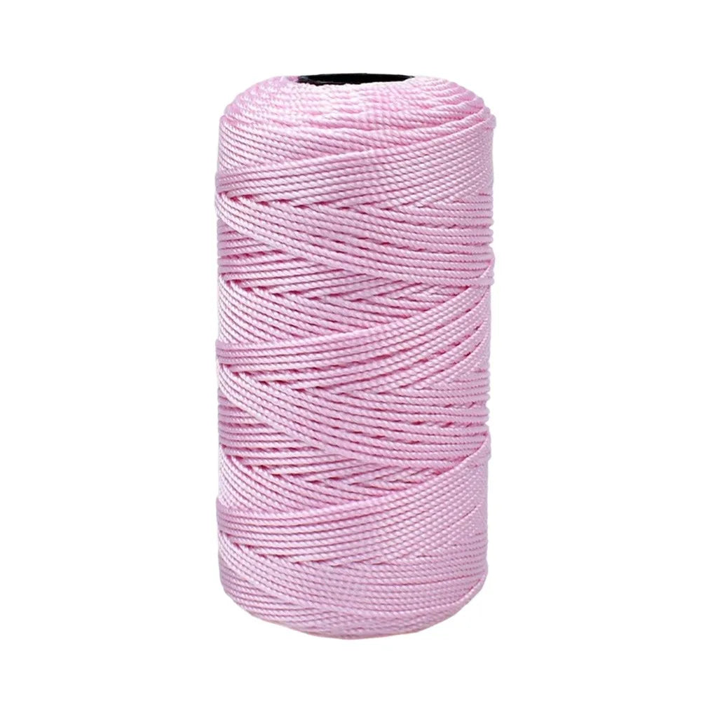 Pink ice cotton silk thread wound into a spool for knitting and crochet