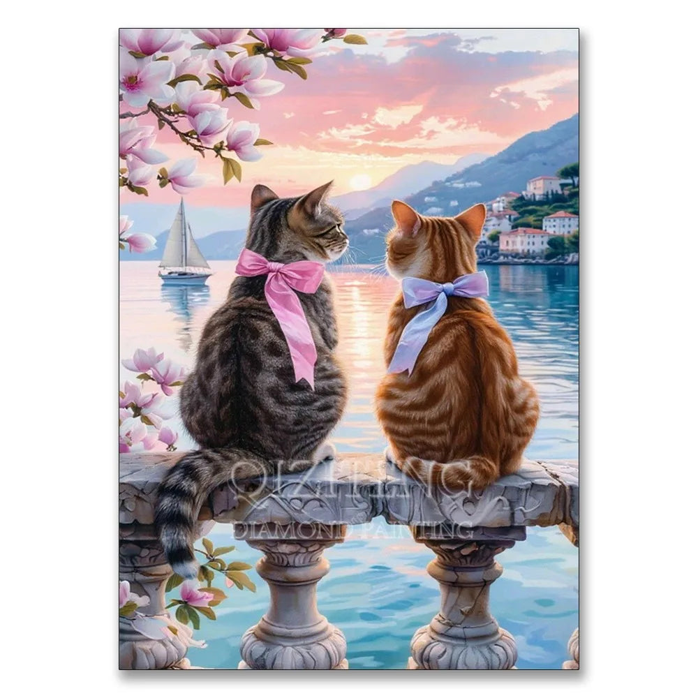 A tabby cat and an orange cat sitting on a stone railing with pink flowers in the background under a sunset sky.