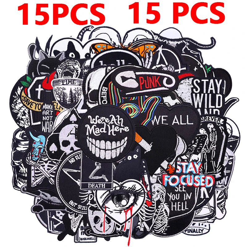 A pile of black embroidered patches featuring punk and rebellious themes for DIY clothing customization.
