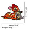 An embroidered patch featuring an orange and gray cat dragon design.