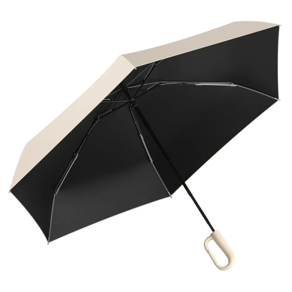 A black compact folding umbrella with a beige canopy is shown open against a white background.