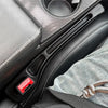 A close-up view of a black car seat gap filler organizer with red accents and stitching, designed for crevice storage.