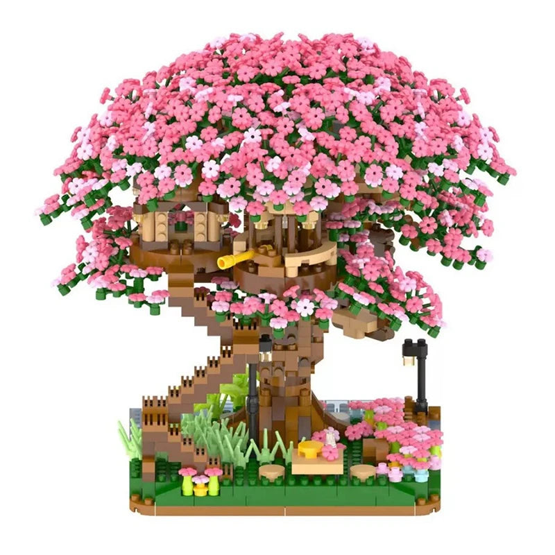 A miniature pink sakura treehouse built from micro building blocks with an LED glow.