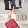 A close-up of a black zippered wallet with card slots and a VIP section, shown being held by hands.