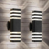Modern up and down LED wall sconce with black and white striped light panels mounted on a gray brick wall.