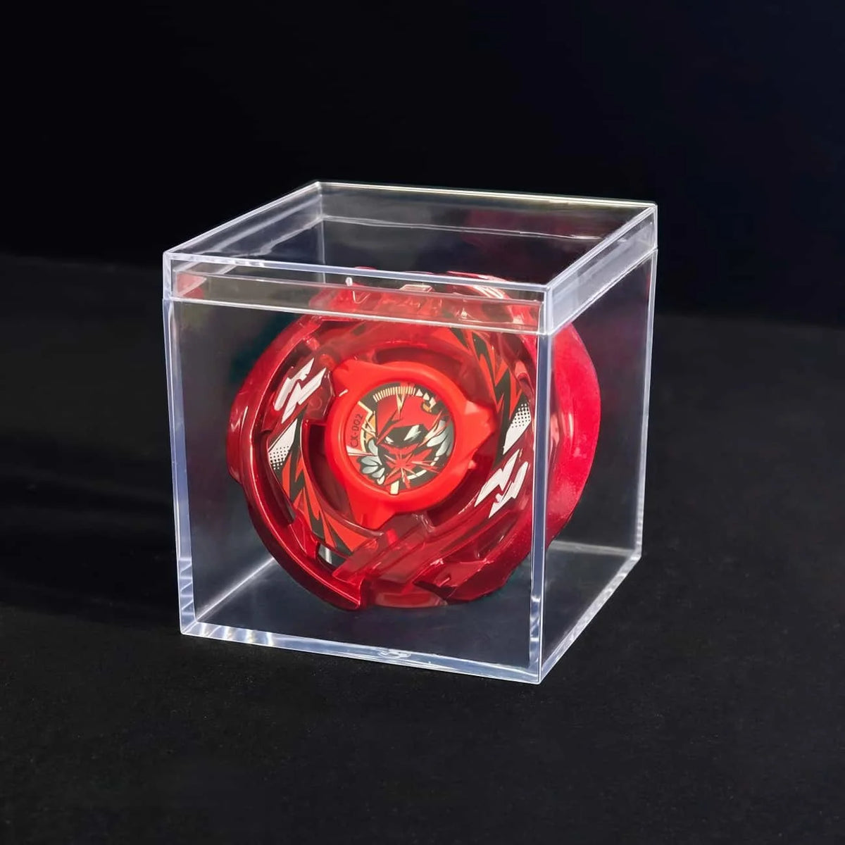 A red Valkyrie Volt S4-70V metal spinning top with launcher displayed inside a clear plastic box.
