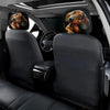Two black car headrest covers featuring cute dachshund illustrations installed in a vehicle interior.
