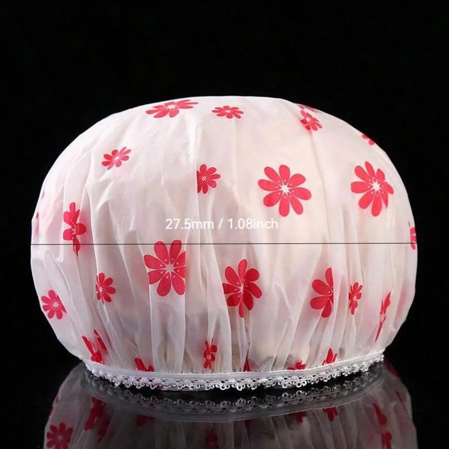 Pink waterproof shower cap with red floral pattern shown from the top.