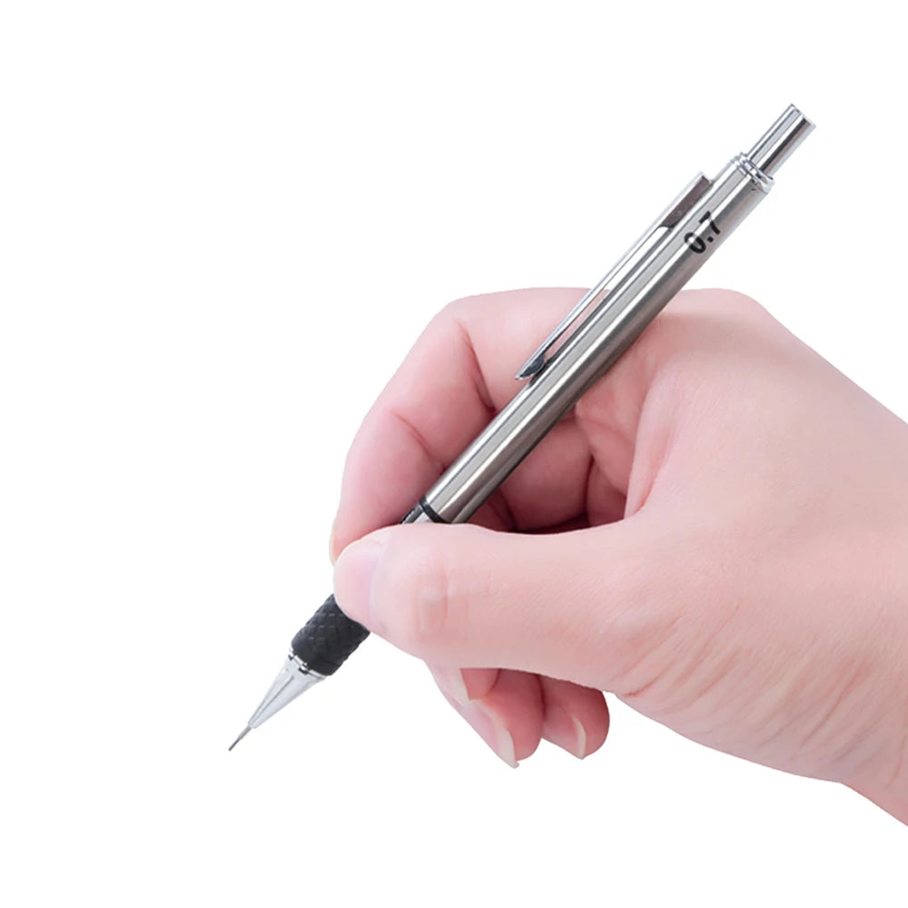 A hand holds a silver metal mechanical pencil with a grip and lead set.