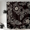Black shower curtain featuring a repeating pattern of gothic skulls, moths, and floral designs.