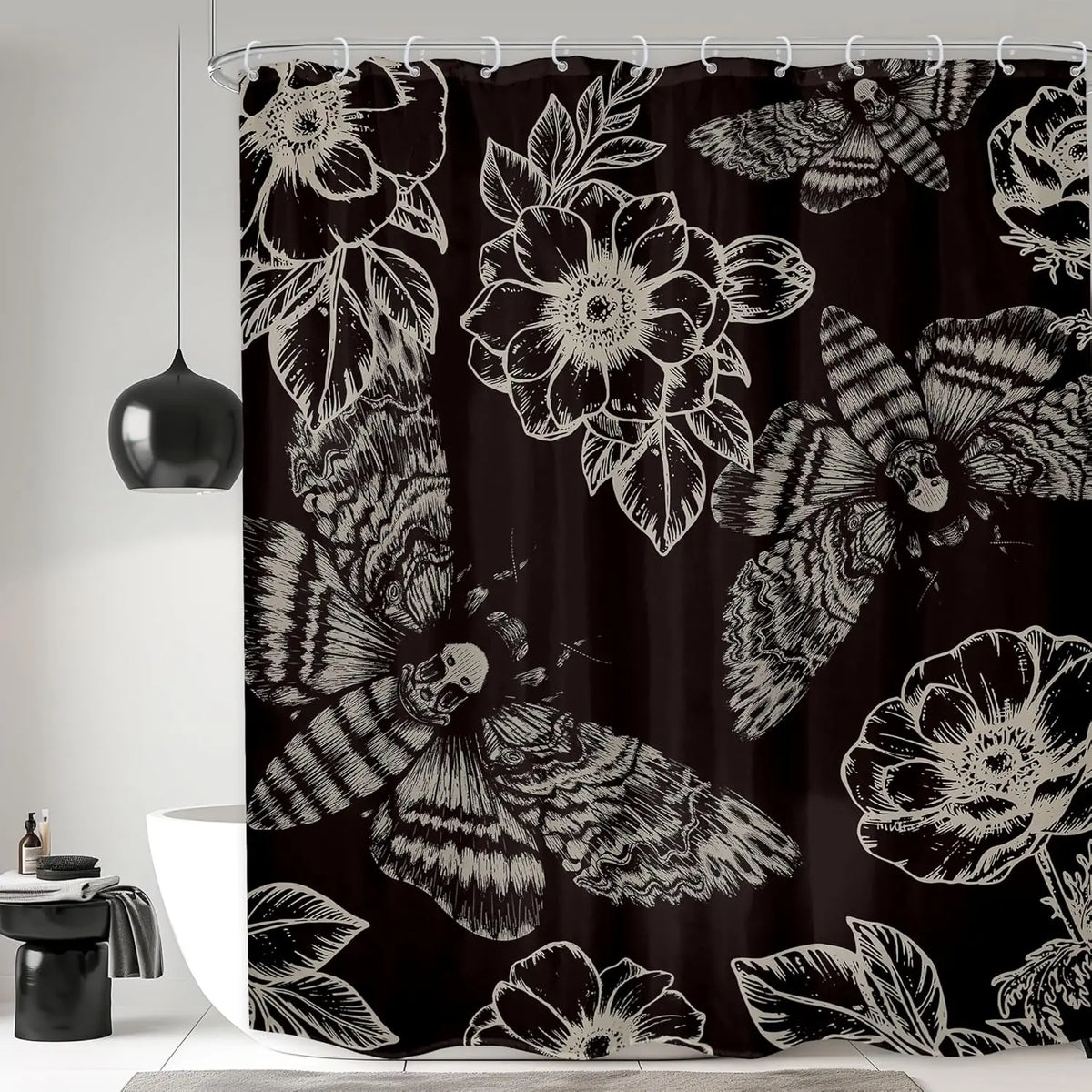 Black shower curtain featuring a repeating pattern of gothic skulls, moths, and floral designs.
