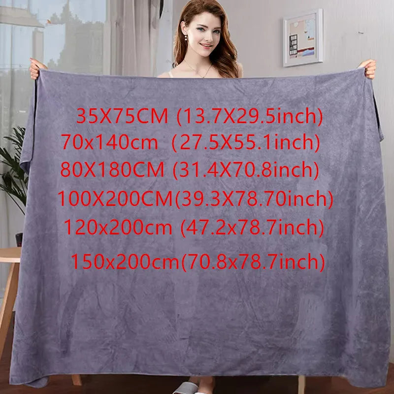 A purple microfiber bath towel is displayed flat, showing various size options written on the fabric.