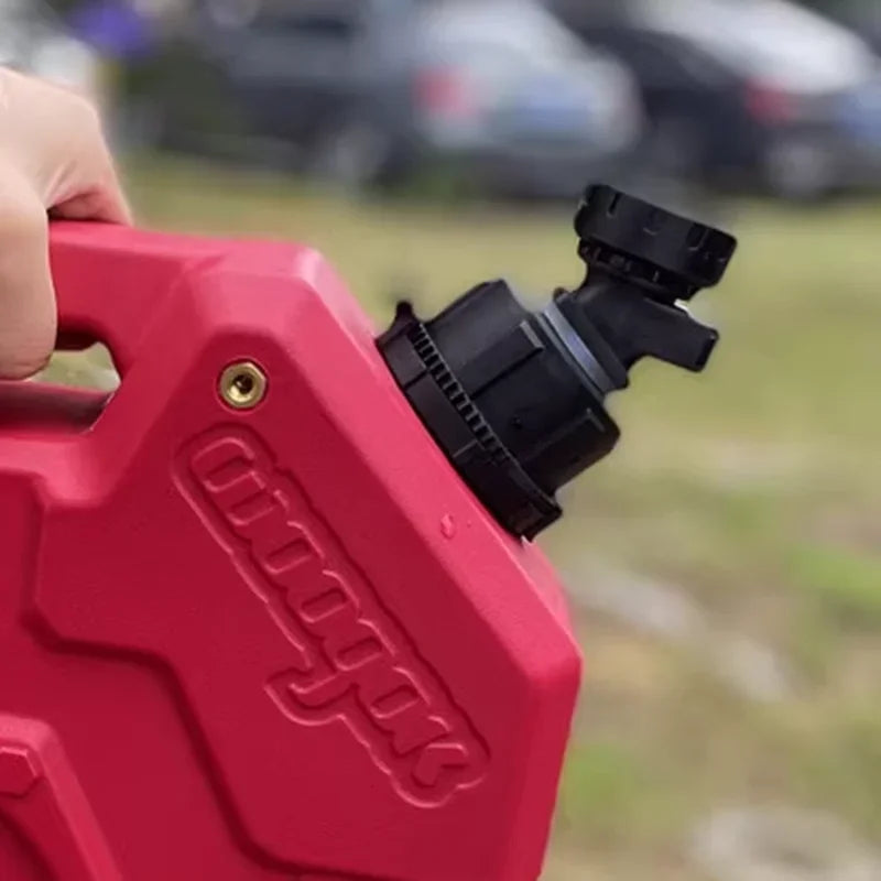 A hand holds a red plastic adapter for a universal water tap faucet, used to connect with Woogok fuel cans.