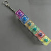 A long keychain featuring a series of colorful, translucent LED mechanical fidget toy keycaps.