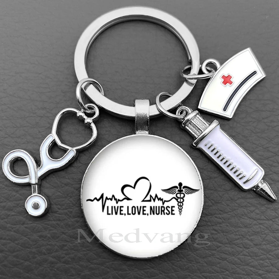 Silver nurse keychain featuring a glass dome charm and a medical syringe accessory.