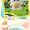 A white panda plush toy standing in a green field with yellow flowers and wooden fencing.