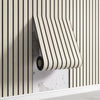A roll of beige and black striped wood grid peel-and-stick wall panels mounted on a white shelf.