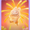 A fluffy, light brown plush doll resembling a rabbit with large ears and a wide smile against an orange background.