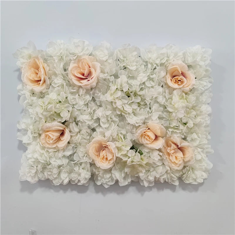 A wall panel covered in white hydrangeas and peach-colored silk rose flowers for weddings and events.