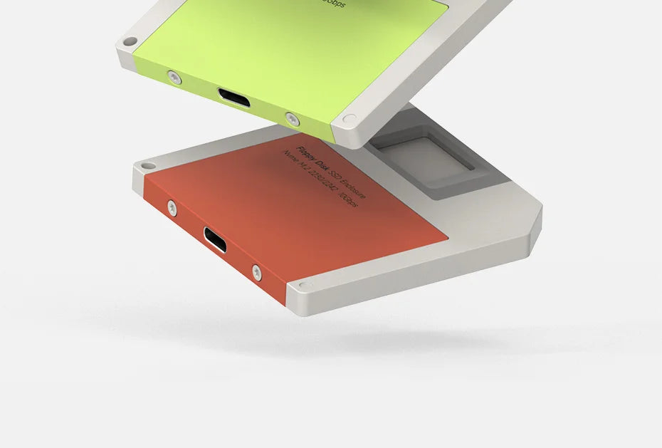 A silver M.2 NVMe SSD enclosure is shown with a lime green adapter, positioned on a white surface.