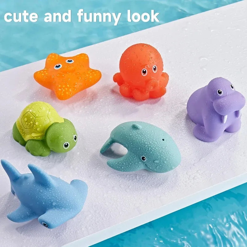A set of colorful floating bath toys including an orange duck, a purple elephant, a green turtle, and a blue shark on a white