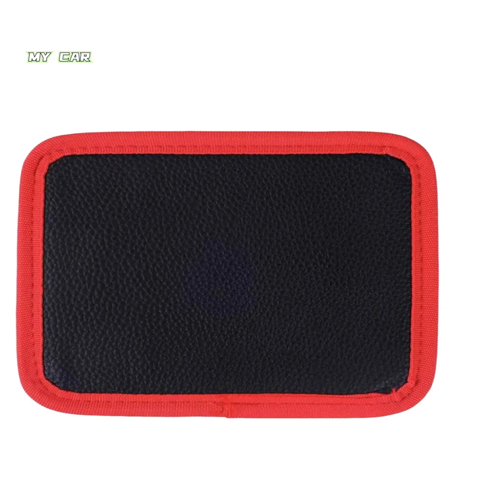 A black tool mat with a red border and magnetic grip for tools.