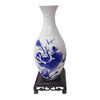 A white ceramic vase with blue floral patterns, designed as a 3D puzzle.